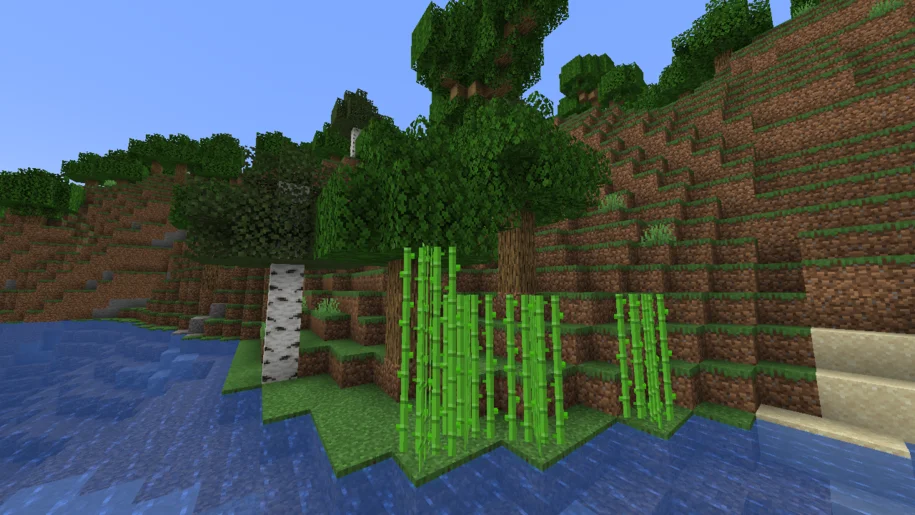 Minecraft river bed with orange birch tree, oak trees and sugar cane